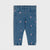 Blue denim baby leggings with small pink embroidered flowers, elastic waistband, and elastic ankle cuffs, shown flat on a light gray background.