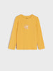Yellow long-sleeve shirt with a floral design on a light gray background
