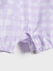 Close-up of a purple checkered garment with floral patterns on a white background