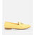 A single yellow suede loafer flat with a small gold-tone horsebit detail on the vamp and a low tan block heel, shown in profile against a light gray background.