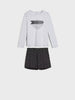 Gray long-sleeve shirt with black geometric design and black shorts on a white background