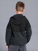 Person wearing a black hoodie from behind on a gray background