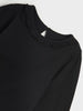 Black long-sleeve top with ruffled neckline on a white background
