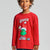 A child wearing a red long-sleeve Grinch graphic t-shirt against a light gray studio background.