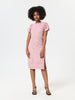 Woman wearing a pink lace dress on a white background
