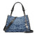 A blue damask-patterned handbag with black leather trim, double top handles, and a silver-tone 'PAR' charm, shown on a plain white background.