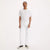 Person wearing a white t-shirt and white pants on a plain background