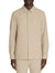 Beige button-up shirt worn by a person on a white background