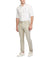 Man wearing a white shirt and beige pants on a white background