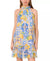 Woman wearing a colorful dress with lemon and tile pattern on a white background