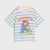 A children's short-sleeve t-shirt with light blue and off-white horizontal stripes, featuring a central graphic of Paddington Bear and the text 'Paddington' in orange.