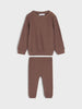 Brown ribbed sweater and pants set on a white background