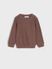 Brown knitted sweater on a light gray background