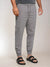 Person wearing gray jogger pants on a plain background