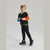 A young boy modeling a color-blocked long-sleeve sweatshirt and matching black pants against a light gray studio background.