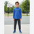 A young boy stands on an outdoor basketball court wearing a bright blue long-sleeve quarter-zip pullover, dark gray jogger pants, and blue athletic sneakers.