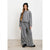 A woman modeling a gray ribbed knit two-piece lounge set consisting of a cropped long-sleeve sweatshirt and matching wide-leg pants, styled with a black beanie and black shoes against a plain white studio background.