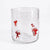 A clear glass tumbler with three red bow illustrations on a plain white background.