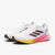 White running shoe with colorful sole on a white background