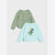 Two children's long-sleeve tops laid flat on a light gray background. The top behind is sage green with a repeating dinosaur print in pastel pink, yellow, and orange.
