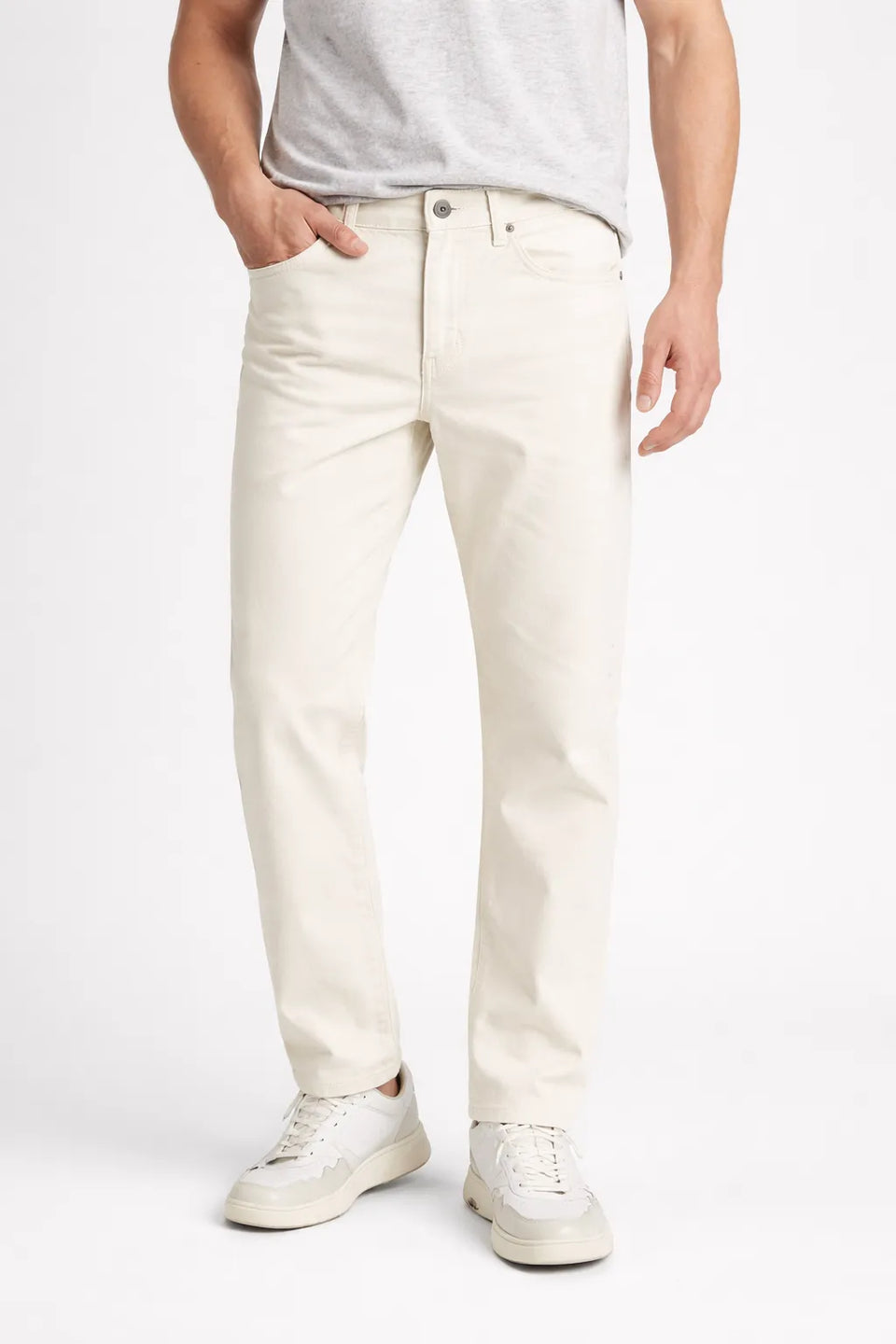 Person wearing white jeans and a light gray shirt on a white background