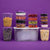 Set of clear food storage containers with various snacks on a purple background