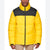 A man wearing a bright yellow puffer jacket with a contrasting black yoke across the shoulders and collar, paired with beige pants, shot against a plain white background.