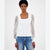 A woman modeling a white ribbed knit top with sheer puff sleeves, paired with blue jeans, against a plain white studio background.