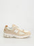 Beige sneaker with white sole on a light gray background