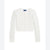 A white cable-knit cropped cardigan sweater with a button-up front, long sleeves, and a small embroidered pink bow on the left cuff, shown flat against a white background.