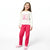 A young girl smiling and wearing a two-piece pajama set consisting of a white long-sleeve top with a pink cartoon bear graphic and bright pink pants, paired with pink slipper shoes, against a plain white background.