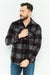 Man wearing a black and gray plaid shirt with blue jeans on a white background