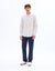 Man wearing a white shirt and blue jeans on a white background