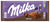 Milka Noisette chocolate bar packaging with a cow illustration on a purple and brown background