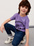 Child wearing a purple t-shirt with 'Excavator' print, sitting on a gray surface.