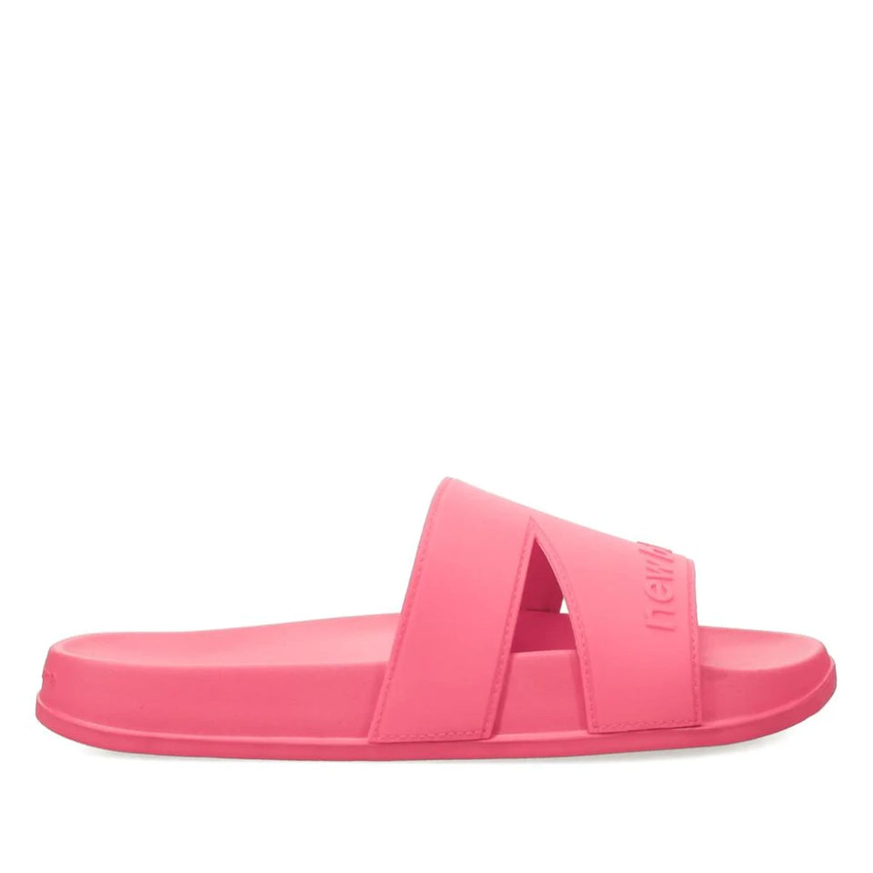 A single pink slide sandal with two wide straps, shown in profile against a plain white background. The brand name 'newme' is embossed on the side of the upper strap.