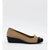 A women's wedge shoe in beige knit with a black toe cap and black wedge heel, featuring a small gold-tone bow on the toe.