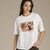 A woman wearing an oversized white short-sleeve t-shirt with a square graphic print of a puppy on a blanket. The brand name 'Kittin' is printed in script below the graphic.