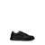 Black sandal with criss-cross straps on a white background