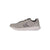 A light gray athletic sneaker with a textured mesh upper, gray laces, a dark gray chevron logo on the side, and a white midsole, shown from a side profile view against a plain white background.