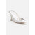 A white pointed-toe slingback pump with a mid-height stiletto heel and a silver rhinestone-embellished bow on the toe, shown against a light gray background.