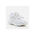 A white chunky platform sneaker with thick laces and a textured sole, shown from a three-quarters angle on a light gray background.