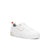 A white low-top platform sneaker with a textured rubber sole, white laces, a small orange pull tab, and a subtle orange stitched accent on the side.