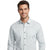 A smiling man wearing a light gray and white patterned long-sleeve button-down shirt, photographed against a solid white background.