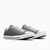 Gray sneakers with white laces on a white background