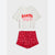 A two-piece kids' holiday pajama set featuring an off-white short-sleeve t-shirt with a red and pink 'SANTA BABY' graphic, paired with red ruffled shorts with a white candy cane and snowflake print.