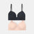Two wireless underwire bras shown flat against a light gray background, one in solid black and the other in soft blush pink.