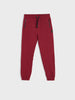 Red sweatpants with black drawstrings on a white background