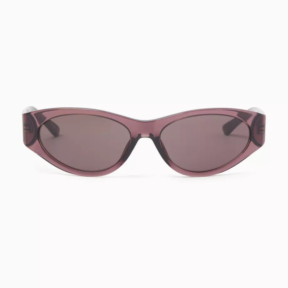 Oversized cat-eye sunglasses with a translucent dusty rose-purple frame and matching tinted lenses, shown against a plain white background.