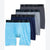 A 4-pack of men's boxer briefs from Jockey, arranged in a staggered fan layout. The set includes a light blue and white striped pair in the front, a dark navy pair, a light gray pair, and a dark charcoal gray pair.